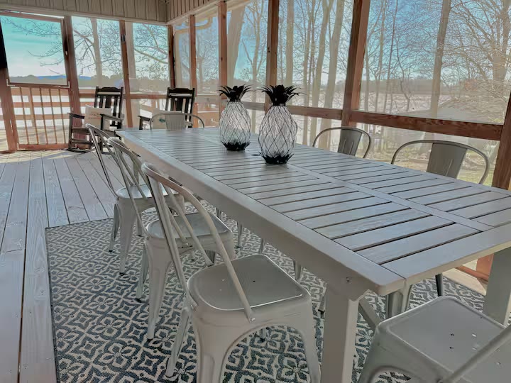 Weiss Lake House with Private Dock screened porch dining at a direct-booking vacation rental in Cedar Bluff, Alabama